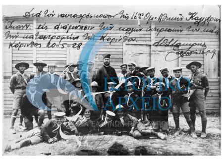 Πρόσκοποι της Αθήνας που προσέφεραν υπηρεσίες μετά το σεισμό στην Κορινθία το 1928. Η φωτογραφία δόθηκε με αφιέρωση από τον Περιφερειακό Έφορο Αθηνών Αθ. Σταμίρη στον πρόσκοπο της 16ης Ομάδας Αθηνών Ιωαν. Καλιγέρη.