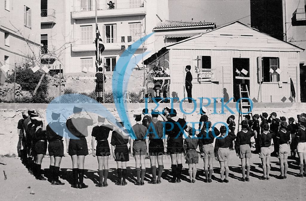 Πρόσκοποι και Λυκόπουλα του 9ου Αθηνών σε έπαρση Σημαίας έξω από την εστία τους στις 25 Μαρτίου 1962.
