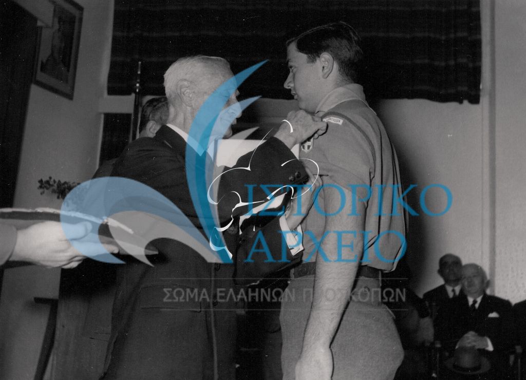 Ο Πρόεδρος ΔΣ ΣΕΠ Μ. Σοφιανός απονέμει την αναγνώριση "Πρόσκοπος Βασιλέως" (σημερινό "Πρόσκοπος Έθνους) το 1959.
