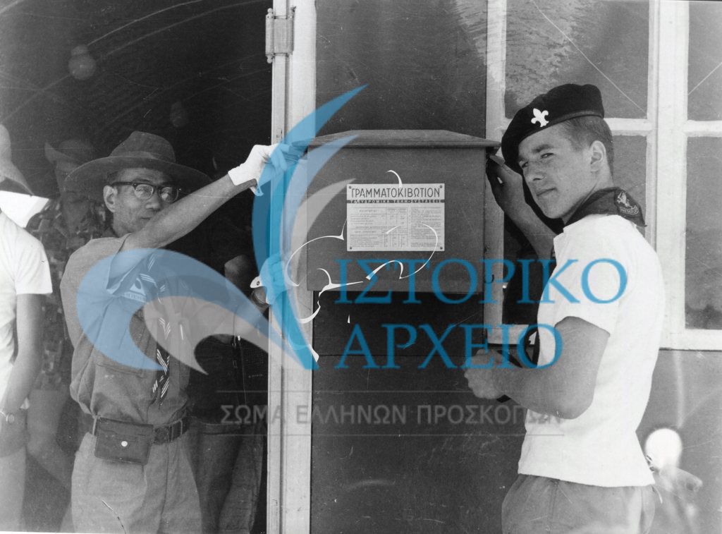 Πρόσκοποι στέλνουν μια κάρτα ή ένα μήνυμα στις πατρίδες τους από το ταχυδρομείο που λειτουργεί στο χώρο της κατασκήνωσης του 11ου Τζάμπορη στο Μαραθώνα το 1963.